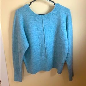 Size M blue polka dot sweater with V line back.